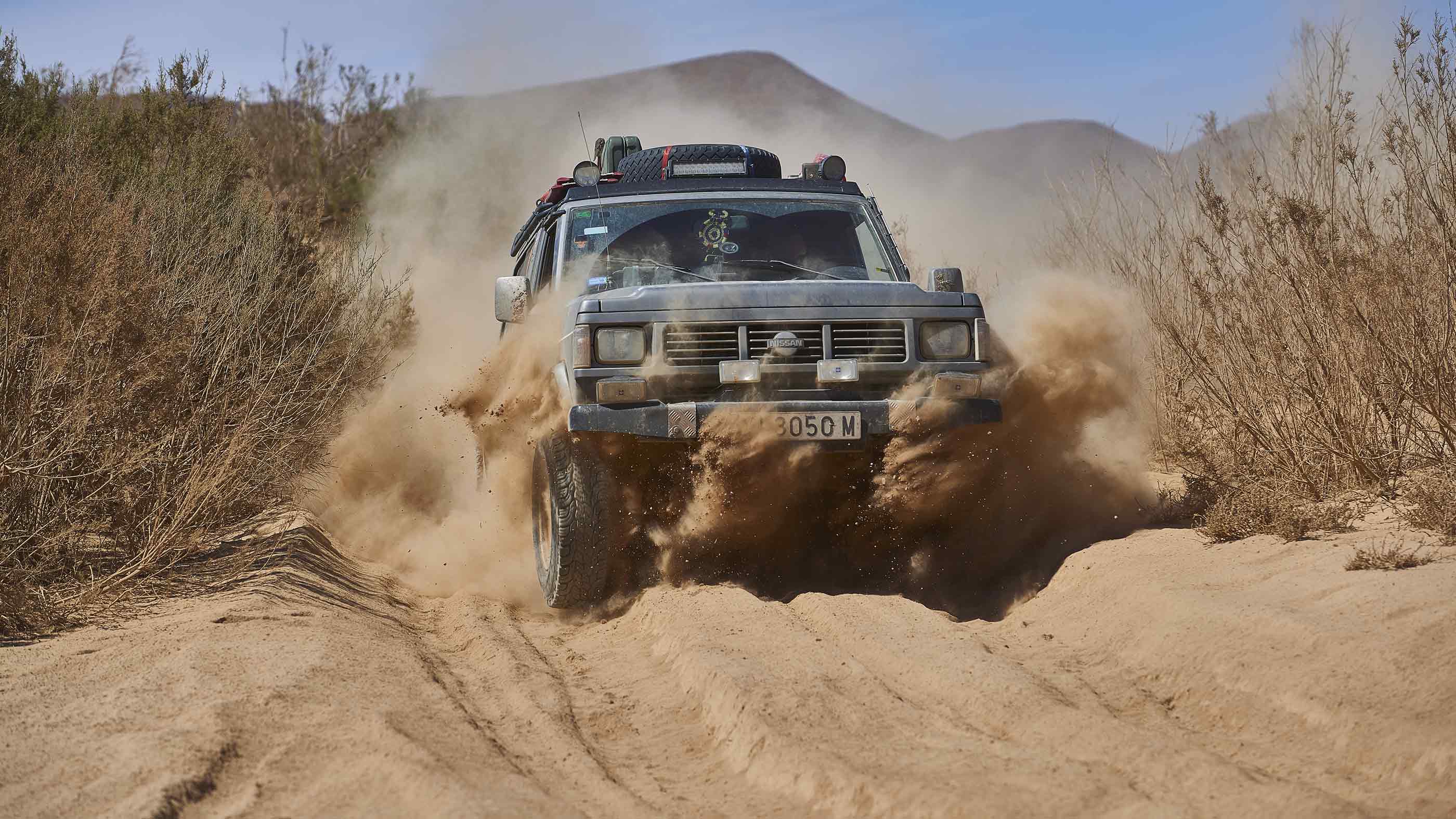 A Nissan Patrol in a sandy pass in Morocco